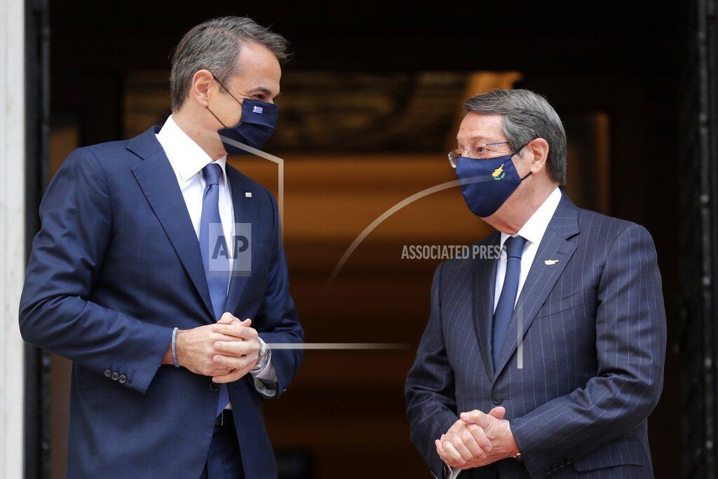 Petros Giannakouris Greece's Prime Minister Kyriakos Mitsotakis, left, welcomes Cypriot President Nicos Anastasiades at Maximos Mansion in Athens, Wednesday, March 24, 2021. The military parade on March 25, marking 200-years since the war that resulted in Greece's independence from the Ottoman Empire and rebirth as a nation, will be held without spectators due to the coronavirus, and only Greek and foreigners political officials. (AP Photo/Petros Giannakouris)