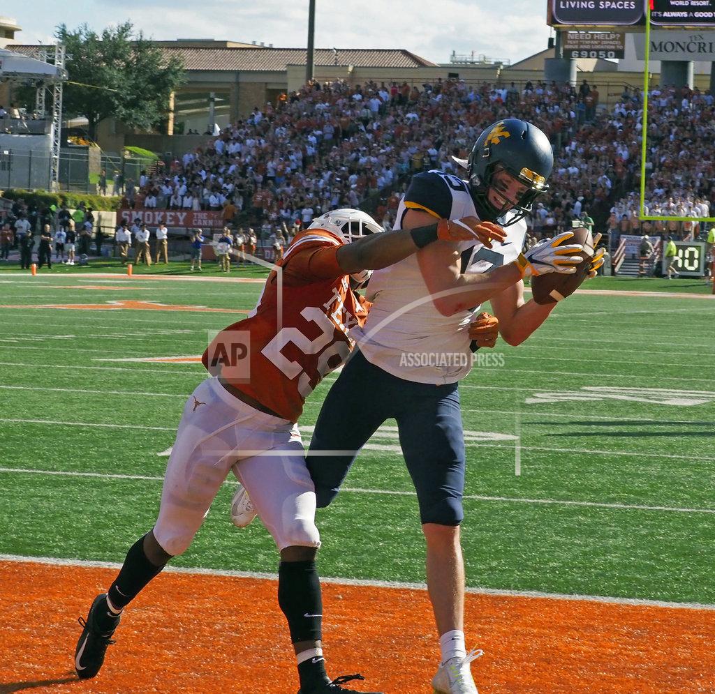 Michael Thomas West Virginia receiver David Sills, V (13) catches a touchdown pass against Texas defensive back Josh Thompson (29) during the first half of an NCAA college football game, Saturday, Nov. 3, 2018, in Austin, Texas. (AP Photo/Michael Thomas)