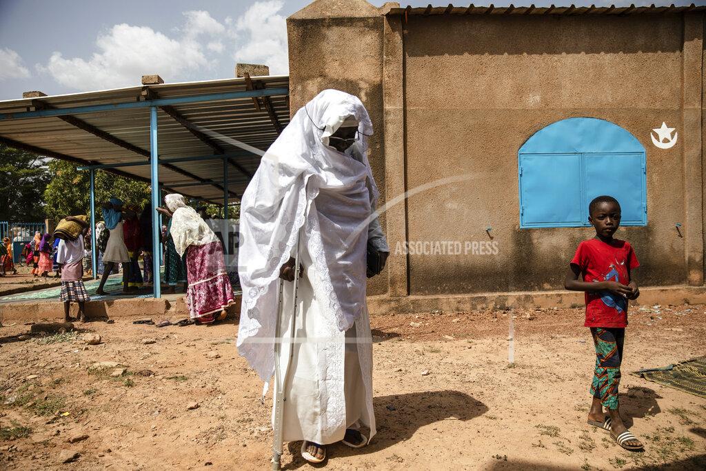 Sophie Garcia Zenabou Coulibaly Zongo, consultant and founding member of the Council of Burkinabe Women, leaves the mosque in Ouagadougou, Burkina Faso, Friday, Oct. 29, 2021. Zongo spends her own money making soap and buying hand sanitizer for mosques, markets and health centers. At the start of the pandemic, Zongo, now 63, was hospitalized with bronchial pneumonia. She paid out of pocket for two weeks' worth of oxygen treatments at a private clinic, where she watched others die from respiratory problems. (AP Photo/Sophie Garcia)
