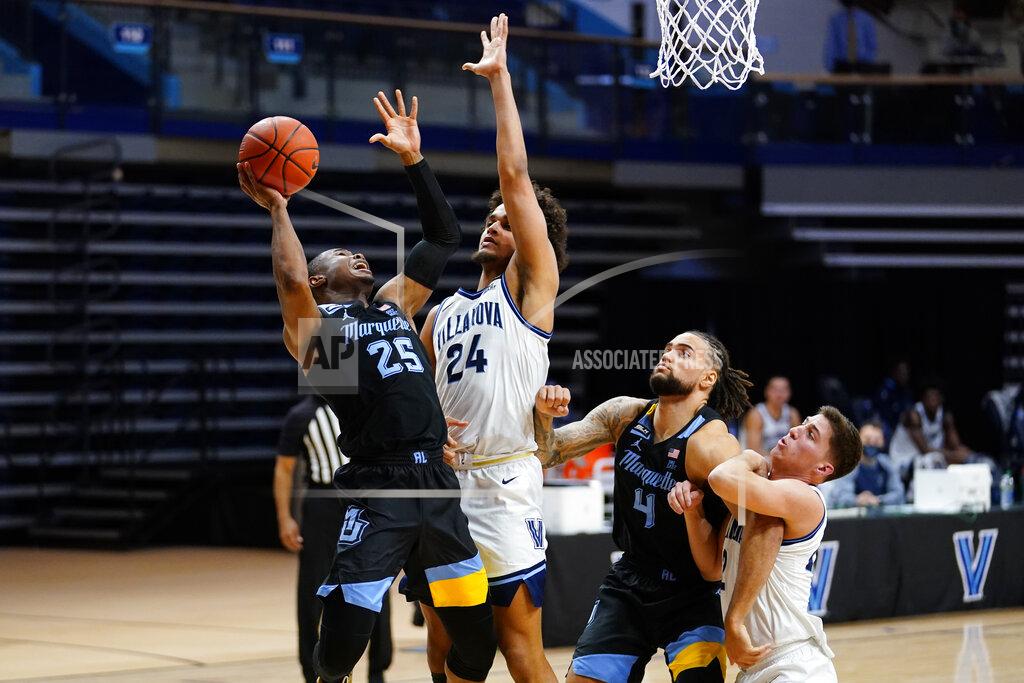 Matt Slocum Marquette's Koby McEwen (25) goes up for a shot against Villanova's Jeremiah Robinson-Earl (24) during the second half of an NCAA college basketball game, Wednesday, Feb. 10, 2021, in Villanova, Pa. (AP Photo/Matt Slocum)