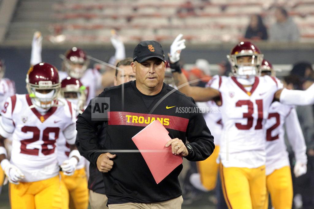 Timothy J. Gonzalez FILE - In this Nov. 3, 2018, file photo, Southern California head coach Clay Helton leads his team onto the field before an NCAA college football game in Corvallis, Ore. Some traditional recruiting heavyweights have plenty of work to do in the next several weeks to sign the level of talent they usually attract each year. As college football’s early signing period concluded Friday, Dec. 21, 2018, Southern California was outside the top 20 and Miami wasn’t in the top 30 of the team standings in composite rankings of recruiting sites compiled by 247Sports. (AP Photo/Timothy J. Gonzalez, File)