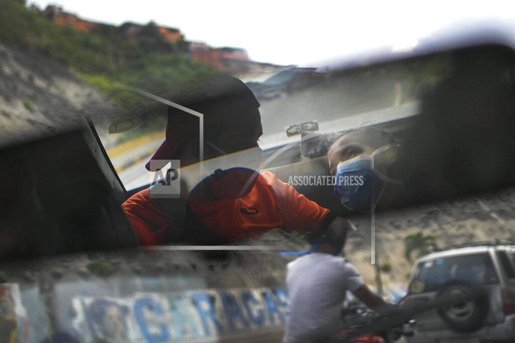Matias Delacroix Reflected in the rearview mirror, Leo Camejo sits with his partner Ada Mendoza and their newborn baby daughter Peyton as a friend drives them home after being discharged from the hospital, in Caracas, Venezuela, Saturday, Sept. 12, 2020. The young couple met three years ago thanks to their love of soccer, as fans of the Caracas F.C. team. (AP Photo/Matias Delacroix)