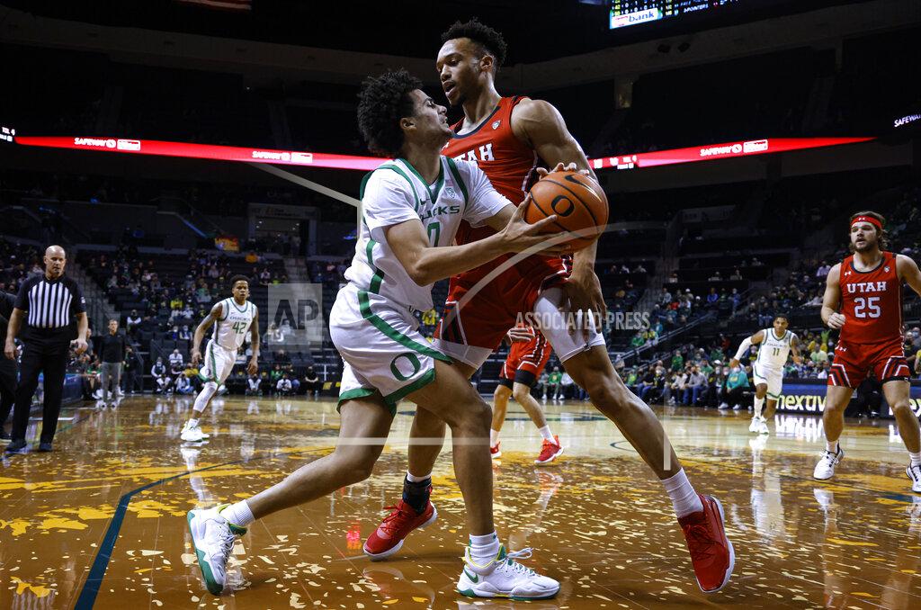 Thomas Boyd Oregon guard Will Richardson (0) drives on Utah guard Marco Anthony during the first half of an NCAA college basketball game in Eugene, Ore., Saturday, Jan. 1, 2022. (AP Photo/Thomas Boyd)