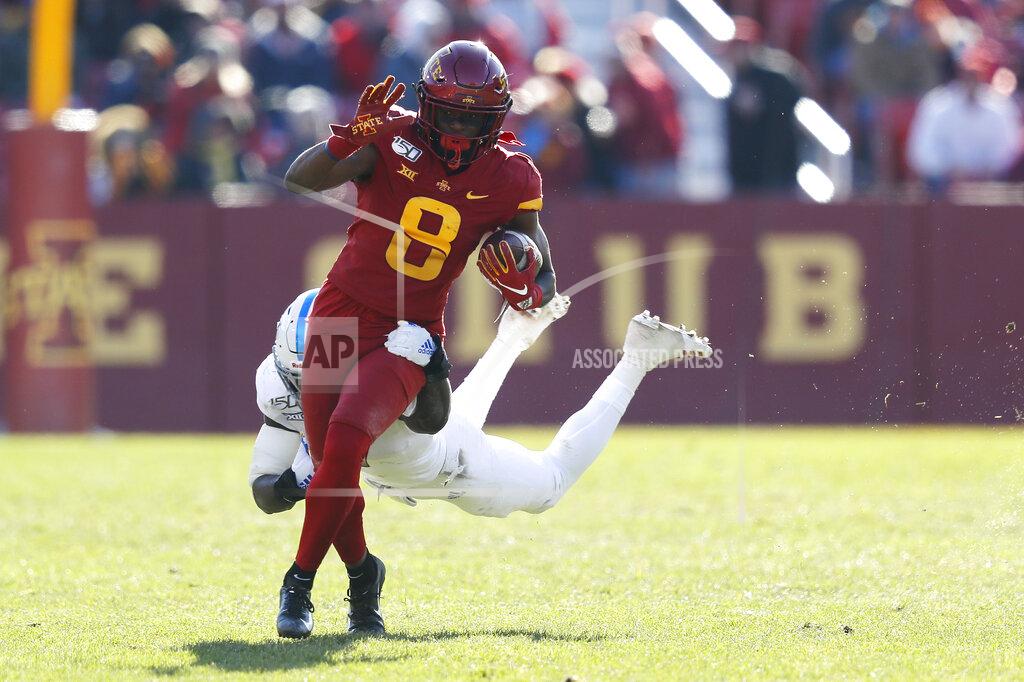 Iowa State wide receiver Deshaunte Jones, left, runs for a first down as Kansas safety Davon Ferguson makes the tackle during the second half of an NCAA college football game, Saturday, Nov. 23, 2019, in Ames, Iowa. Iowa State won 41-31. (AP Photo/Matthew Putney)