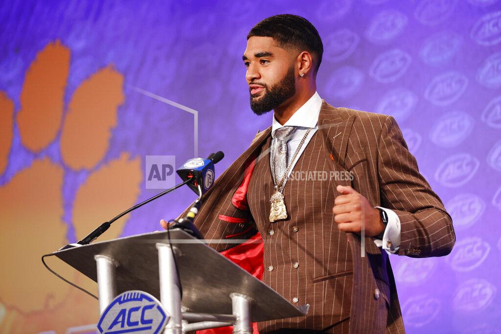 Nell Redmond Clemson quarterback DJ Uiagalelei shows his suit as he answers a question during an NCAA college football news conference at the Atlantic Coast Conference Media Days in Charlotte, N.C., Wednesday, July 20, 2022. (AP Photo/Nell Redmond)