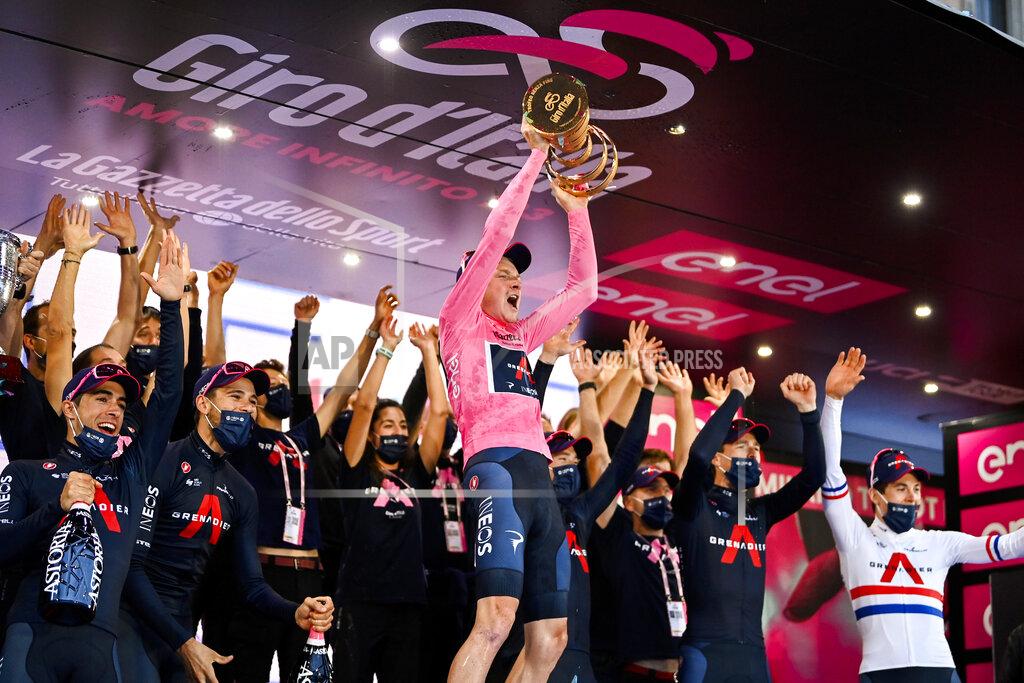 Marco Alpozzi Britain’s Tao Geoghegan Hart holds aloft the trophy as he celebrates with teammates after winning the Giro d'Italia cycling race, in Milan, Italy, Sunday, Oct. 25, 2020. In one of the most exciting final stages of a Grand Tour, British rider Tao Geoghegan Hart won the Giro d’Italia on Sunday, edging out Australian Jai Hindley by just 39 seconds. (Marco Alpozzi/LaPresse via AP)