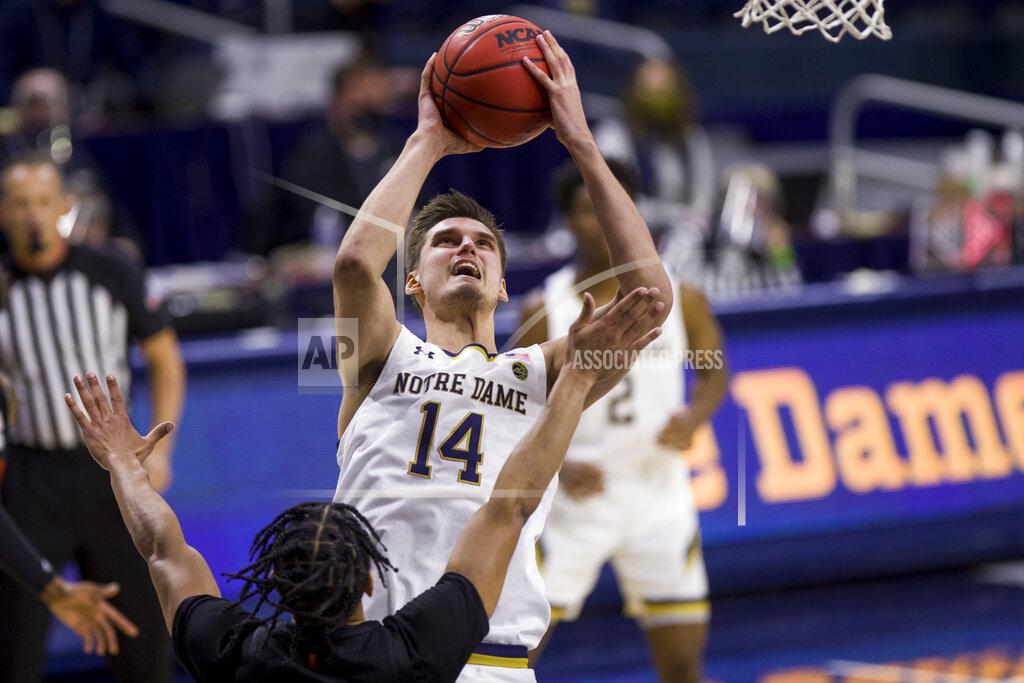 Robert Franklin Notre Dame's Nate Laszewski (14) goes up for a shot over Miami's Isaiah Wong during the second half of an NCAA college basketball game Sunday, Feb. 14, 2021, in South Bend, Ind. Notre Dame won 71-61. (AP Photo/Robert Franklin)