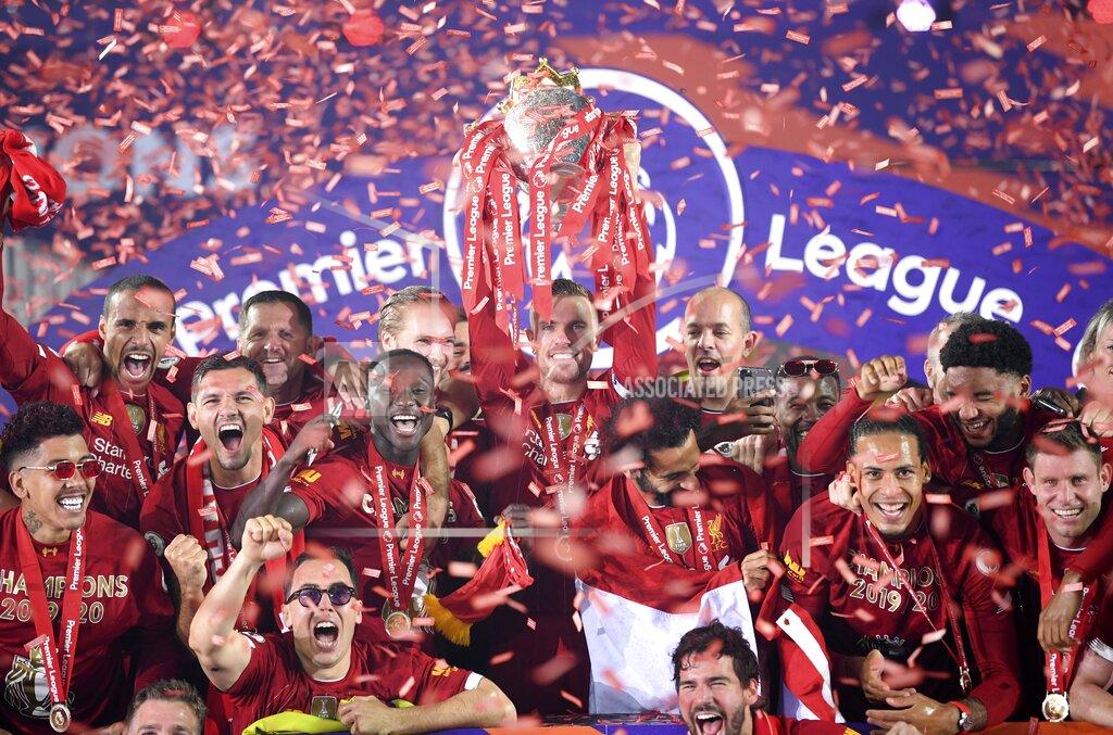 Laurence Griffiths Liverpool's Jordan Henderson lifts the English Premier League trophy following the English Premier League soccer match between Liverpool and Chelsea at Anfield Stadium in Liverpool, England, Wednesday, July 22, 2020. Liverpool are champions of the EPL for the season 2019-2020. The trophy is presented at the teams last home game of the season. Liverpool won the match against Chelsea 5-3. (Laurence Griffiths, Pool via AP)