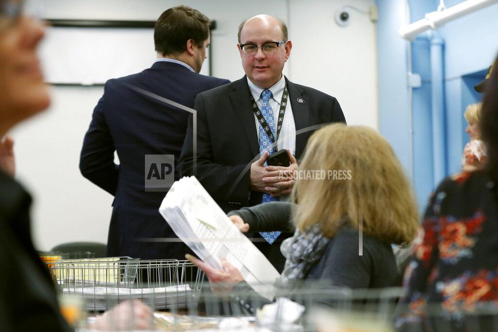 FILE - In this Dec. 6, 2018, file photo, Maine Secretary of State Matt Dunlap oversees the recounting of ballots in the state's 2nd Congressional District, in Augusta, Maine. Dunlap is wrapping up his tenure after a frenetic four-year span in which he ushered in rules for voter-approved ranked-choice voting. Several Democrats hope to replace him when the new legislature convenes in December 2020. (AP Photo/Robert F. Bukaty, File)