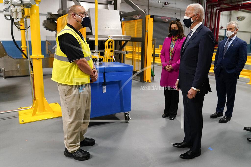 President Joe Biden, Michigan Gov. Gretchen Whitmer, third from right, and Jeff Zients, White House coronavirus response coordinator, right, tour a Pfizer manufacturing site, Friday, Feb. 19, 2021, in Portage, Mich. (AP Photo/Evan Vucci)
