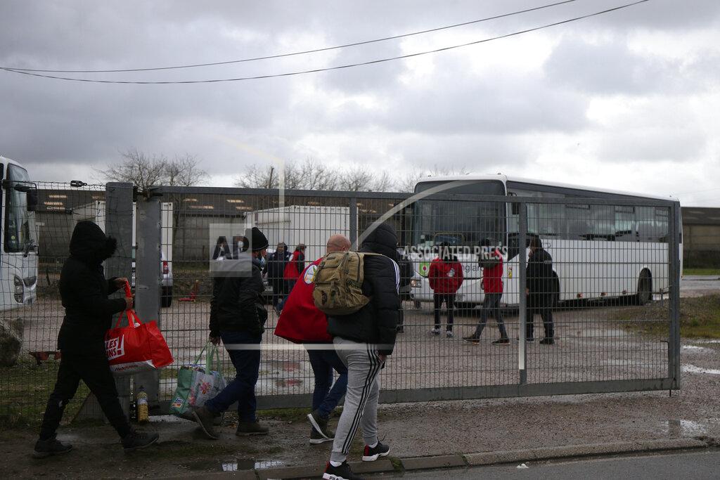 Michel Spingler Migrants who fail to cross the Channel arrive at NGO center to get dry clothes, Thursday, Nov. 25, 2021 in Calais, northern France. Children and pregnant women were among at least 27 migrants who died when their small boat sank in an attempted crossing of the English Channel, a French government official said Thursday. French Interior Minister Gerald Darmanin also announced the arrest of a fifth suspected smuggler thought to have been involved in what was the deadliest migration tragedy to date on the dangerous sea lane.(AP Photo/Michel Spingler)