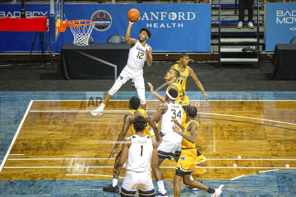 Josh Jurgens West Virginia guard Taz Sherman (12) shoots over a VCU defender during the first half of an NCAA college basketball game Thursday, Nov. 26, 2020, in SIoux Falls, S.D. (AP Photo/Josh Jurgens)