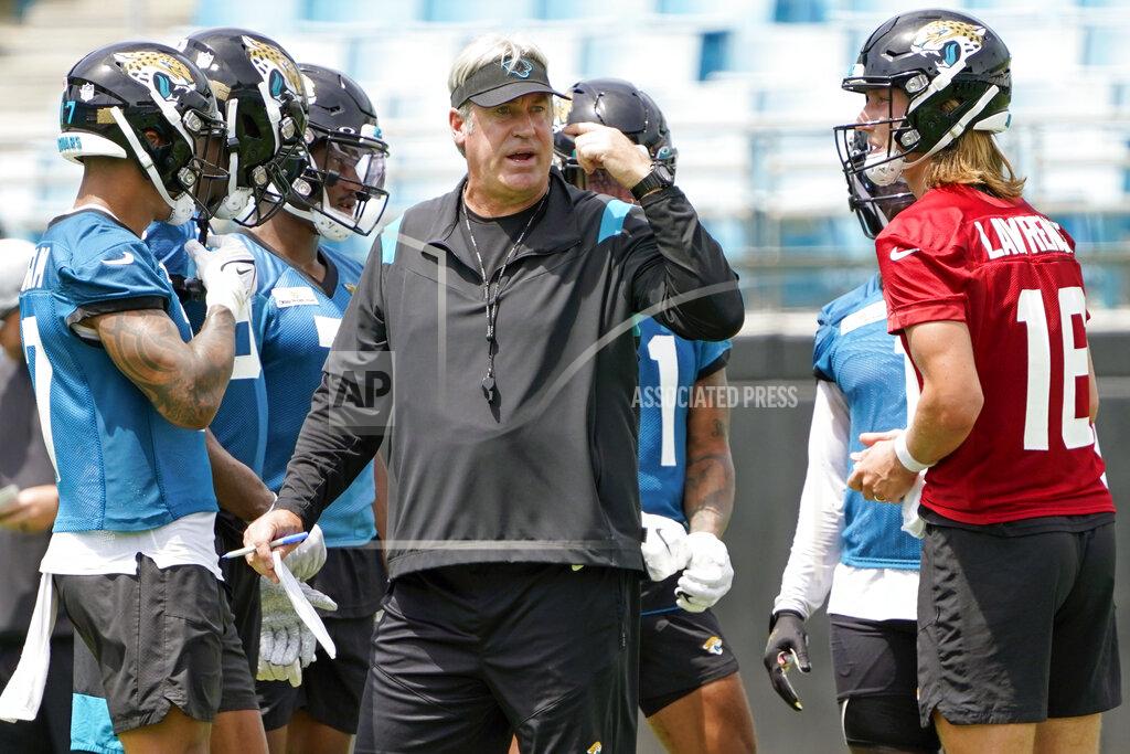 John Raoux Jacksonville Jaguars head coach Doug Pederson, center, directs an NFL football practice, Monday, May 23, 2022, in Jacksonville, Fla. At right is quarterback Trevor Lawrence. (AP Photo/John Raoux)