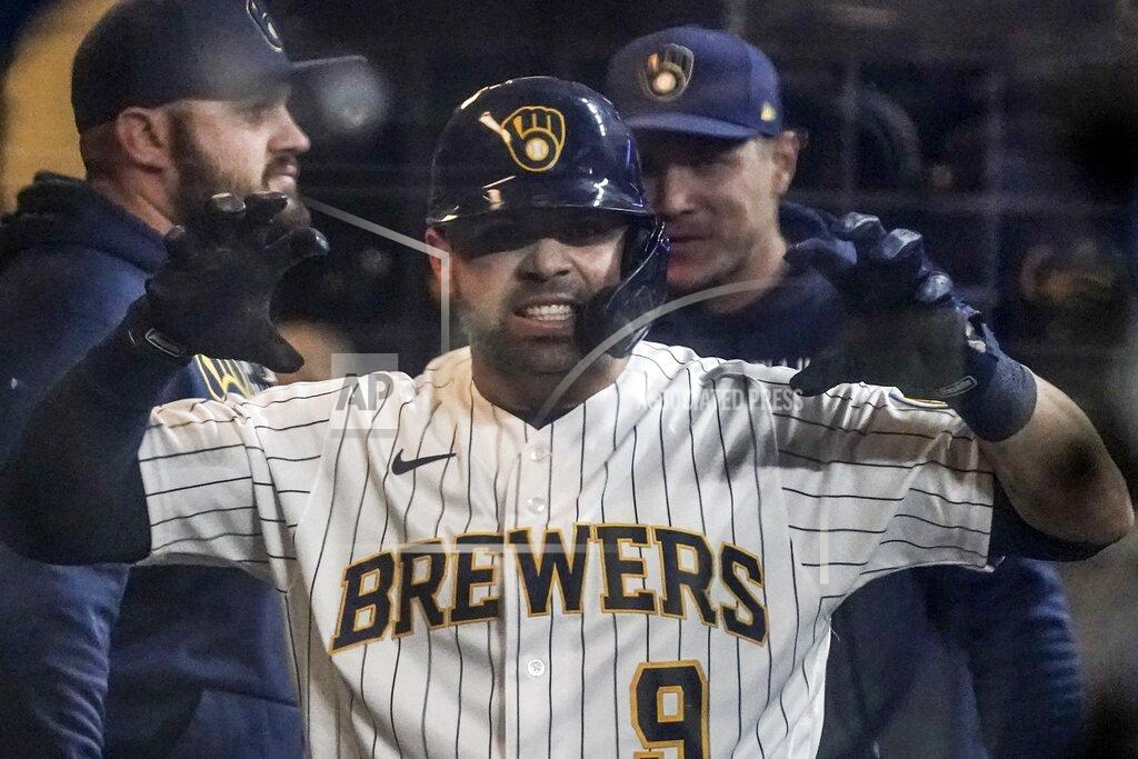 Morry Gash Milwaukee Brewers' Manny Pina reacts after hitting a home run during the eighth inning of a baseball game against the Chicago Cubs Saturday, Sept. 18, 2021, in Milwaukee. (AP Photo/Morry Gash)