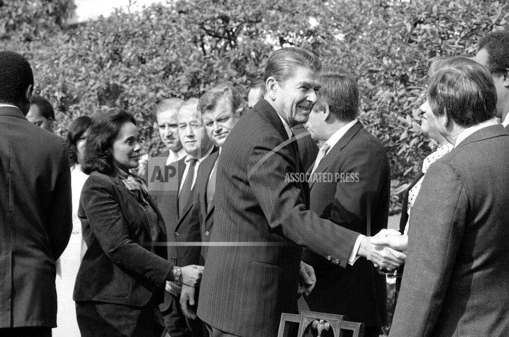 Barry Thumma FILE - In this Nov. 2, 1983 file photo President Ronald Reagan, followed by Coretta Scott King, shakes hands with those in attendance to witness the signing of the bill making Martin Luther King, Jr.'s birthday a national holiday, in the Rose Garden. From left: King; Rep. Joe Biden, D-Del.; Sen. Charles McC. Mathias, R-Md.; Sen. Edward M. Kennedy, D-Mass.; Sen. Bob Dole, R-Kan.; Reagan; and Rep. Katie Hall, D-Ind. (AP Photo/Barry Thumma, File)