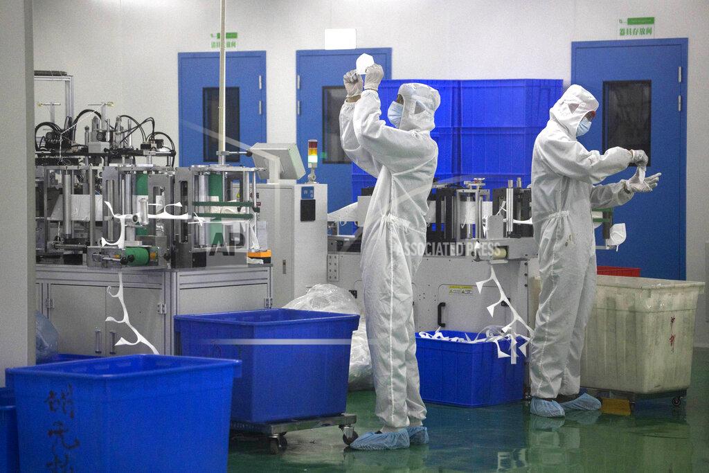Ng Han Guan In this April 12, 2020, photo, workers inspect masks at a mask factory production line of the Wuhan Zonsen Medical Products Co. Ltd. in Wuhan in central China Hubei province. The United States, Japan and France are prodding their companies to rely less on China to make the world’s smartphones, drugs and other products. But even after the coronavirus derailed global trade, few are willing to give up access to its skilled workers, vast market and efficient suppliers by moving factories closer to home.(AP Photo/Ng Han Guan)