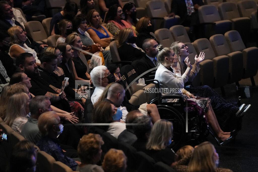 Rebecca Blackwell Angela Gonzalez, second from right, and daughter Deven, right, attend in wheelchairs due to their injuries, during the funeral service for their late husband and father Edgar Gonzalez, 44, who was killed last month in the Champlain Towers South condominium collapse, on Friday, July 23, 2021, at Christ Fellowship church in Palmetto Bay, Fla. Angela and Deven were injured but survived the collapse, falling multiple stories.(AP Photo/Rebecca Blackwell)