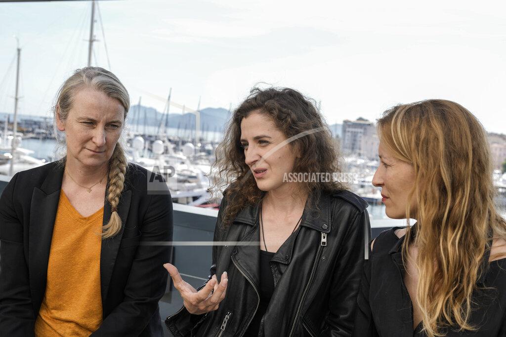Petros Giannakouris Nadia Turincev, from left, Hanna Bilobrova and Dounia Sichov are interviewed by the Associated Press discussing the film 'Mariupolis 2' at the 75th international film festival, Cannes, southern France, Thursday, May 19, 2022. (AP Photo/Petros Giannakouris)