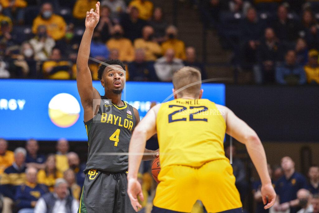 William Wotring Baylor guard LJ Cryer (4) signals while being guarded by West Virginia guard Sean McNeil (22) during the second half of an NCAA college basketball game in Morgantown, W.Va., Tuesday, Jan. 18, 2022. (William Wotring)