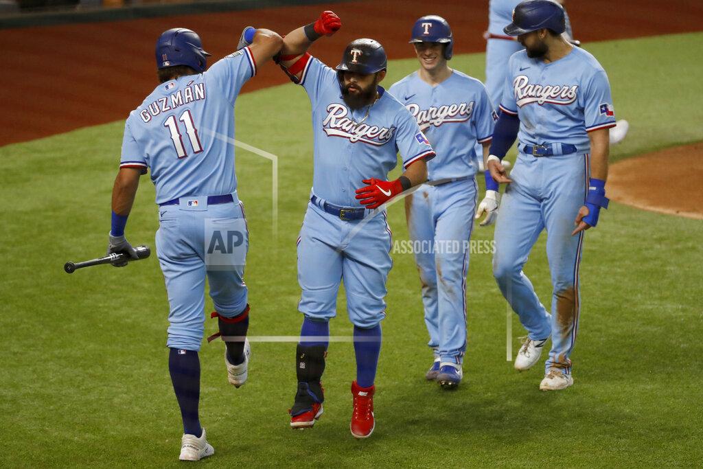 Roger Steinman Texas Rangers' Ronald Guzman (11) congratulates Rougned Odor, second from left, for hitting a three-run home run while Nick Solak, second from right, and Joey Gallo, right, look on during the fourth inning of a baseball game against the Houston Astros in Arlington, Texas, Sunday, Sept. 27, 2020. (AP Photo/Roger Steinman)