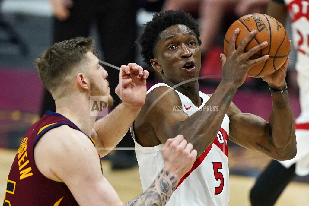 Tony Dejak Toronto Raptors' Stanley Johnson, right, drives to the basket against Cleveland Cavaliers Isaiah Hartenstein in the second half of an NBA basketball game, Saturday, April 10, 2021, in Cleveland. (AP Photo/Tony Dejak)