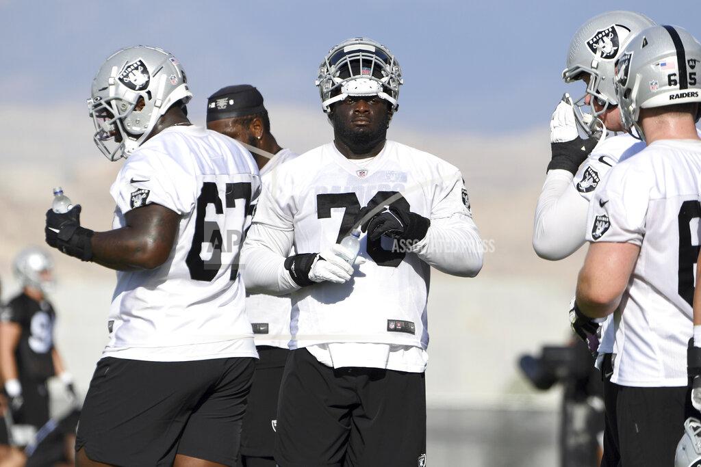 David Becker Las Vegas Raiders offensive tackle Alex Leatherwood (70) and teammates take a break during an NFL football practice Saturday, July 31, 2021, in Henderson, Nev. (AP Photo/David Becker)