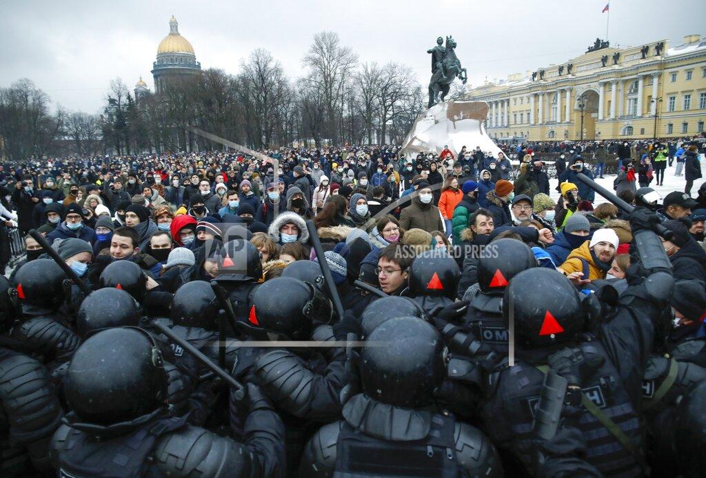 Dmitri Lovetsky People clash with police during a protest against the jailing of opposition leader Alexei Navalny in St.Petersburg, Russia, Saturday, Jan. 23, 2021. Russian police on Saturday arrested hundreds of protesters who took to the streets in temperatures as low as minus-50 C (minus-58 F) to demand the release of Alexei Navalny, the country's top opposition figure. A Navalny, President Vladimir Putin's most prominent foe, was arrested on Jan. 17 when he returned to Moscow from Germany, where he had spent five months recovering from a severe nerve-agent poisoning that he blames on the Kremlin. (AP Photo/Dmitri Lovetsky)