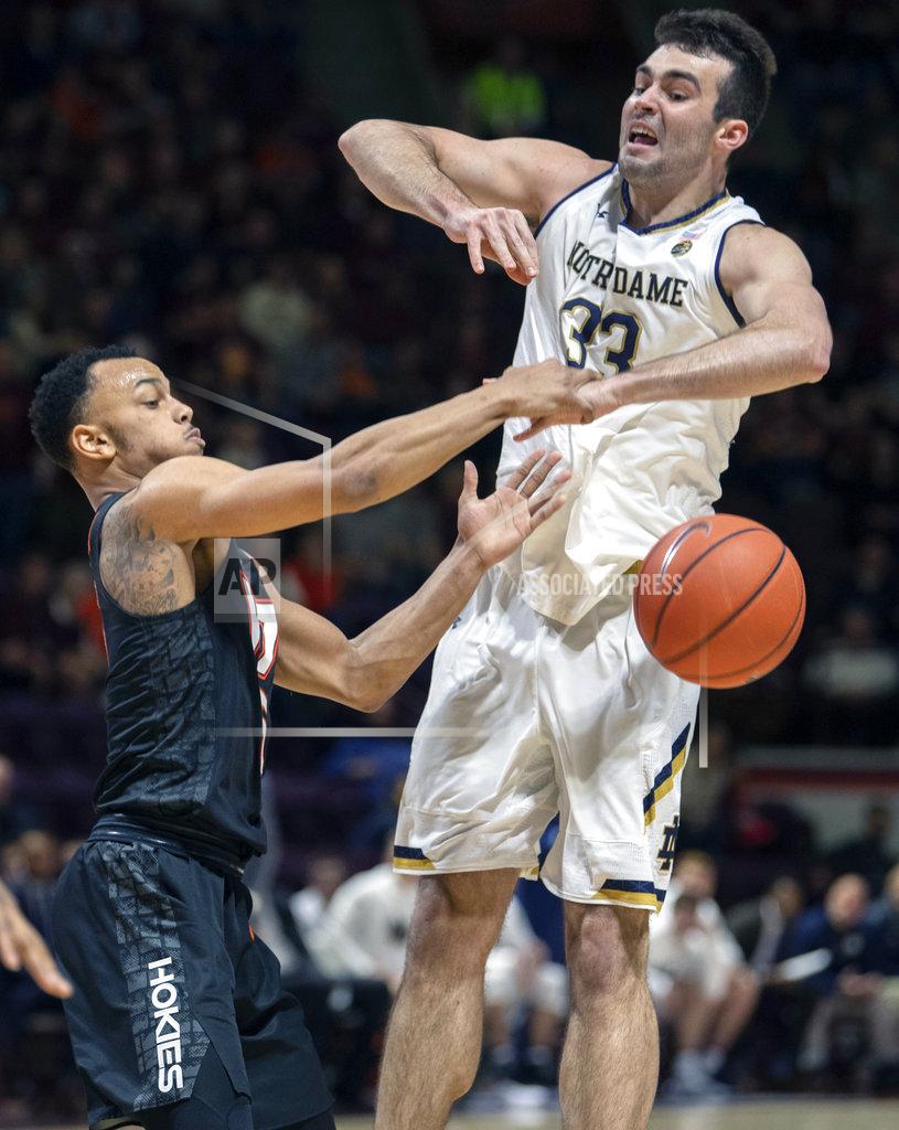Don Petersen Virginia Tech guard Justin Robinson (5) and Notre Dame forward John Mooney (33) battle for a loose ball during the first half of an NCAA college basketball game Tuesday, Jan. 1, 2019, in Blacksburg, Va. (AP Photo/Don Petersen)