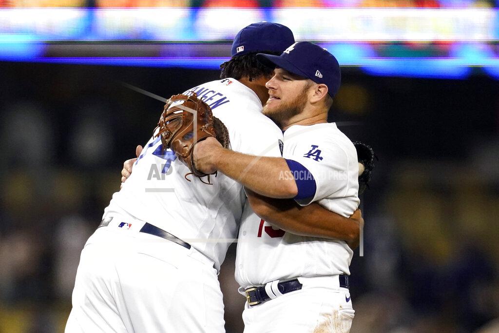 Marcio Jose Sanchez Los Angeles Dodgers relief pitcher Kenley Jansen, left, hugs Max Muncy after the Dodgers' 8-4 win over the Arizona Diamondbacks in a baseball game Tuesday, Sept. 14, 2021, in Los Angeles. (AP Photo/Marcio Jose Sanchez)