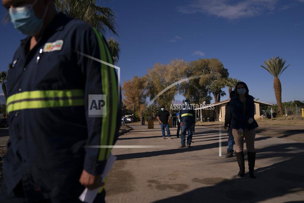 Jae C. Hong Hispanic farm workers wait in line to receive the Pfizer-BioNTech COVID-19 vaccine in Mecca, Calif., Thursday, Jan. 21, 2021. The farmworkers who got their shots are among the millions of immigrants around the United States, who advocacy groups warn may be some of the most difficult people to reach during the largest vaccination campaign in American history. (AP Photo/Jae C. Hong)
