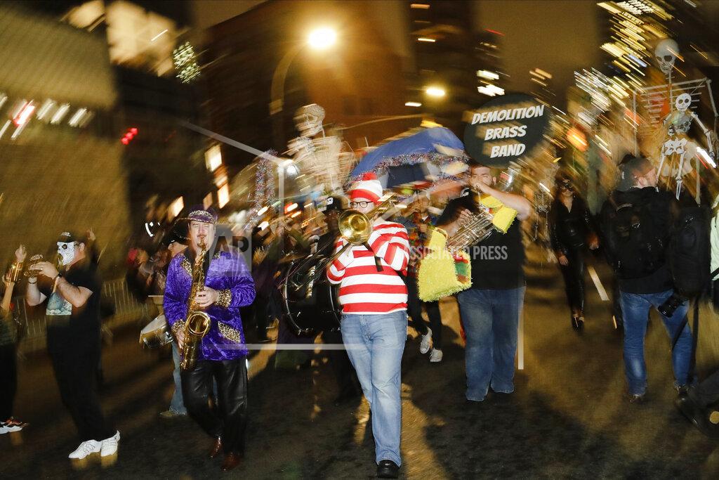 Frank Franklin Ii FILE- In this Oct. 31, 2019 file photo, revelers march in the Greenwich Village Halloween Parade in New York. This year's parade was canceled by the coronavirus pandemic, but fun and spooky activities planned around the city included a puppet parade, an Empire State Building memory game and socially distant trick-or-treating. (AP Photo/Frank Franklin II)