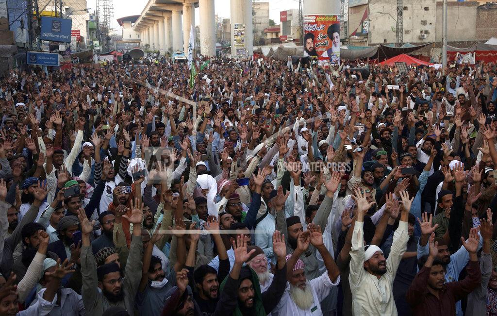 K.M. Chaudary Supporters of Tehreek-e-Labaik Pakistan, a radical Islamist political party, chant religious slogans during a sit-in protest demanding release of their leader Saad Rizvi, in Lahore, Pakistan, Thursday, Oct. 21, 2021. Thousands of Islamists are demanding the release of Rizvi, who was arrested in April amid protest against France over depictions of Islam's Prophet Muhammad. (AP Photo/K.M. Chaudary)