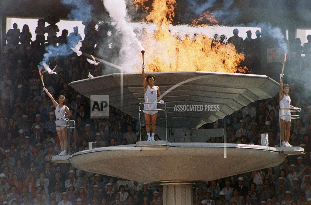 Michel Lipchitz Pigeons fly around as the Olympic torch is lit during opening ceremonies in Seoul Sept. 17, 1988. (AP Photo/Michel Lipchitz)