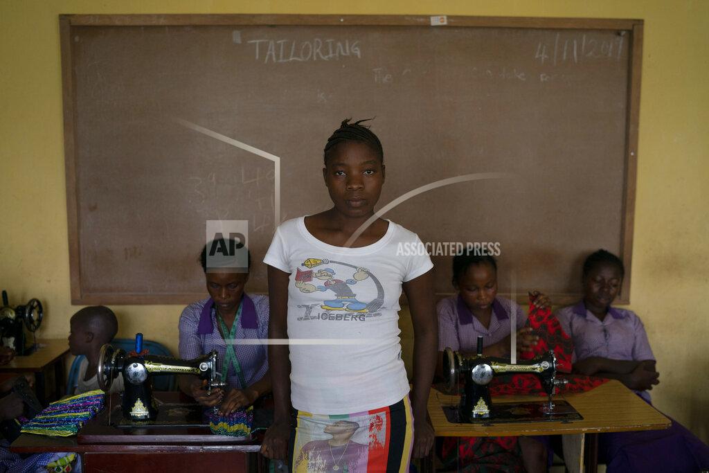 Leo Correa Naomi poses for a portrait at a tailoring classroom in the district of Kono, Sierra Leone, Monday, Nov. 23, 2020. "My family are farmers and don't have money to put me in the school, that's why they gave me on marriage", says the teenager, who ran away from her husband's house after realizing that he already had another wife. (AP Photo/Leo Correa)