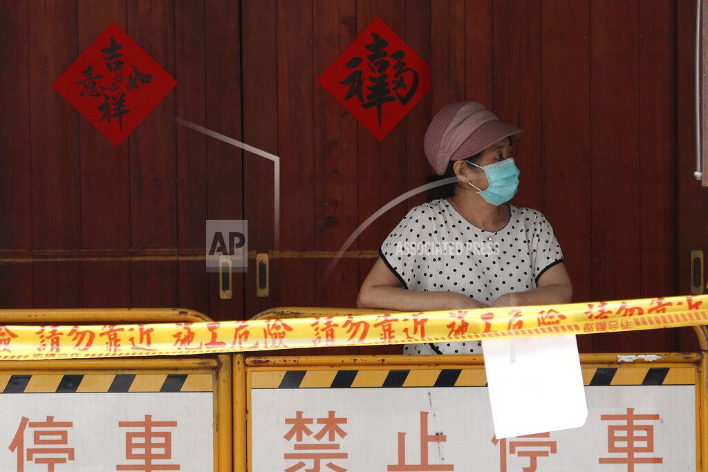 Chiang Ying-Ying FILE - In this May 18, 2021, file photo, a woman wearing face mask to protect against the spread of the coronavirus lines up at a rapid coronavirus testing center after the infection alert rose to level 3 in Taipei, Taiwan. After a year of success, Taiwan is struggling with its largest outbreak since the pandemic began. When locally transmitted cases started being found in May 2021, it soon became clear that the central government was ill prepared not only to contain them, but to even detect them on a large scale due to a lack of investment in and a bias against rapid testing. (AP Photo/Chiang Ying-ying, File)