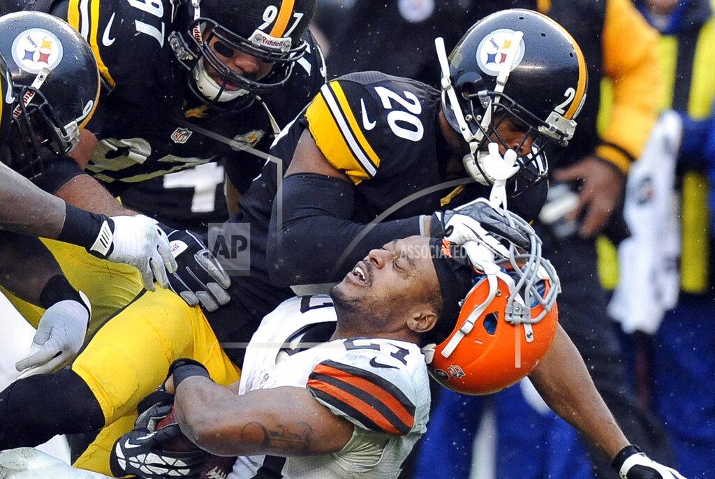 FILE - In this Dec. 29, 2013, file photo, Cleveland Browns running back Edwin Baker (27) loses his helmet as he is tackled by Pittsburgh Steelers strong safety Will Allen (20) in the third quarter of an NFL football game in Pittsburgh. The Steelers won 20-7. Whether playing in Three Rivers Stadium or at Heinz Field, most of Cleveland's trips down the Turnpike and across the Pennsylvania state line have not gone well. The Browns are just 6-41 on their visits to the Steel City since 1970. (AP Photo/Don Wright, File)