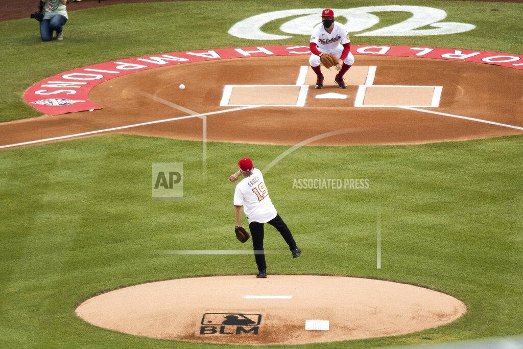 Andrew Harnik Director of the National Institute of Allergy and Infectious Diseases Dr. Anthony Fauci throws out the ceremonial first pitch at Nationals Park before the New York Yankees and the Washington Nationals play an opening day baseball game, Thursday, July 23, 2020, in Washington. (AP Photo/Andrew Harnik)
