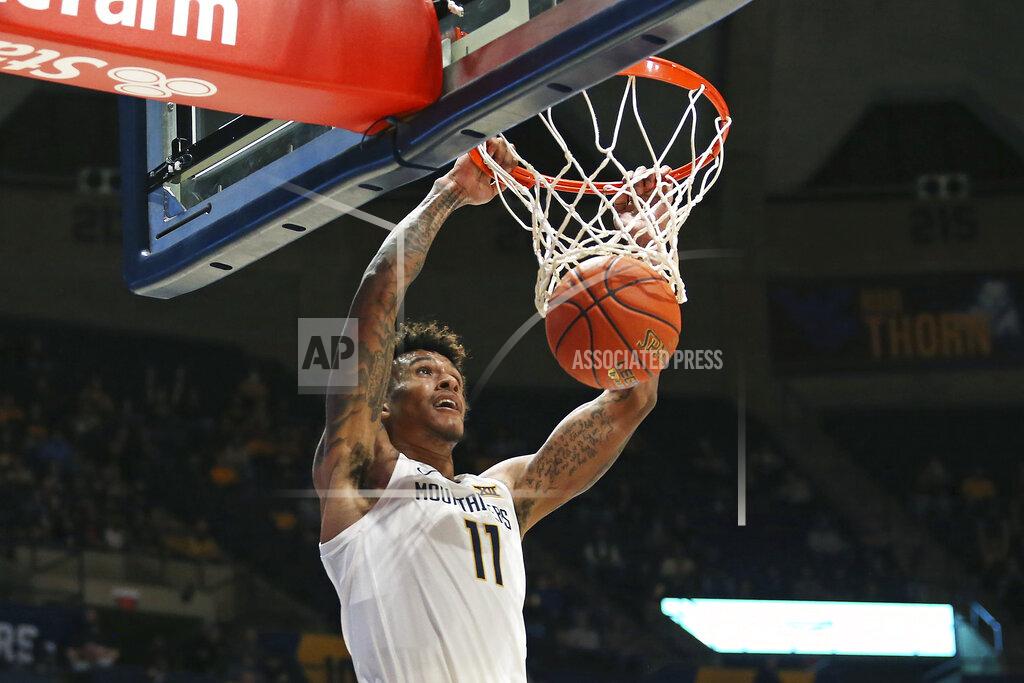 Kathleen Batten West Virginia forward Jalen Bridges (11) dunks against Oakland during the second half of an NCAA college basketball game in Morgantown, W.Va., Tuesday, Nov. 9, 2021. (AP Photo/Kathleen Batten)