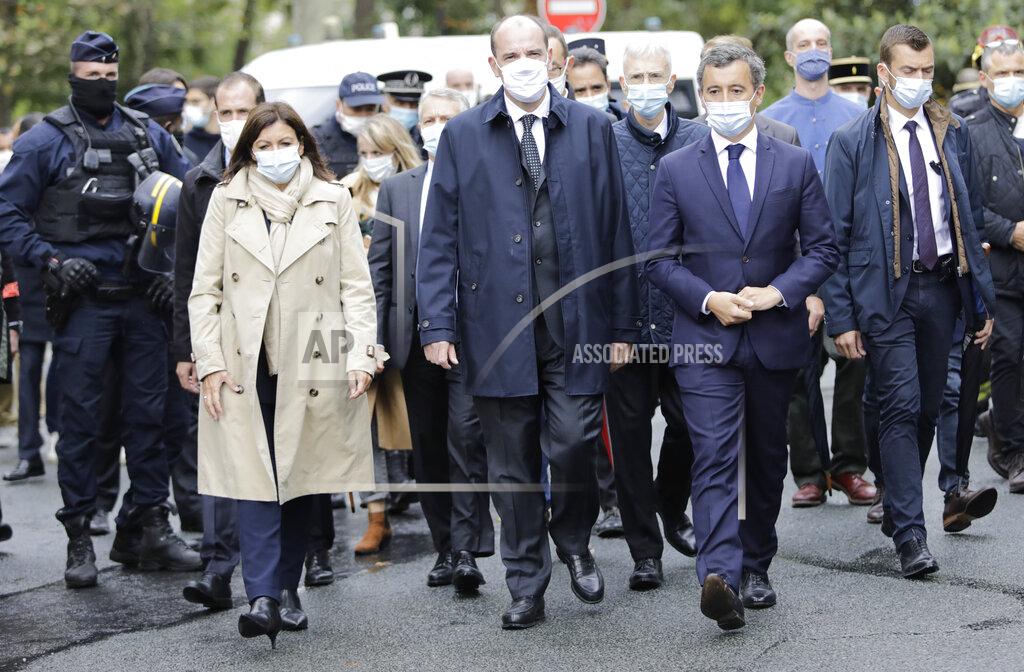 From the left, Paris mayor Anne Hidalgo, France Prime Minister Jean Castex, and Interior Minister Gerald Darmanin arrive on the scene after a knife attack near the former offices of satirical newspaper Charlie Hebdo, Friday Sept. 25, 2020 in Paris. French terrorism authorities are investigating a knife attack that wounded at least two people Friday near the former offices of the satirical newspaper Charlie Hebdo in Paris, authorities said. A suspect has been arrested. (AP Photo/Lewis Joly)
