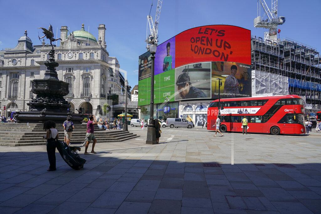Alberto Pezzali People walk in Piccadilly Circus, in London, Monday, June 14, 2021. British Prime Minister Boris Johnson is expected to confirm Monday that the next planned relaxation of coronavirus restrictions in England will be delayed as a result of the spread of the delta variant first identified in India. (AP Photo/Alberto Pezzali)