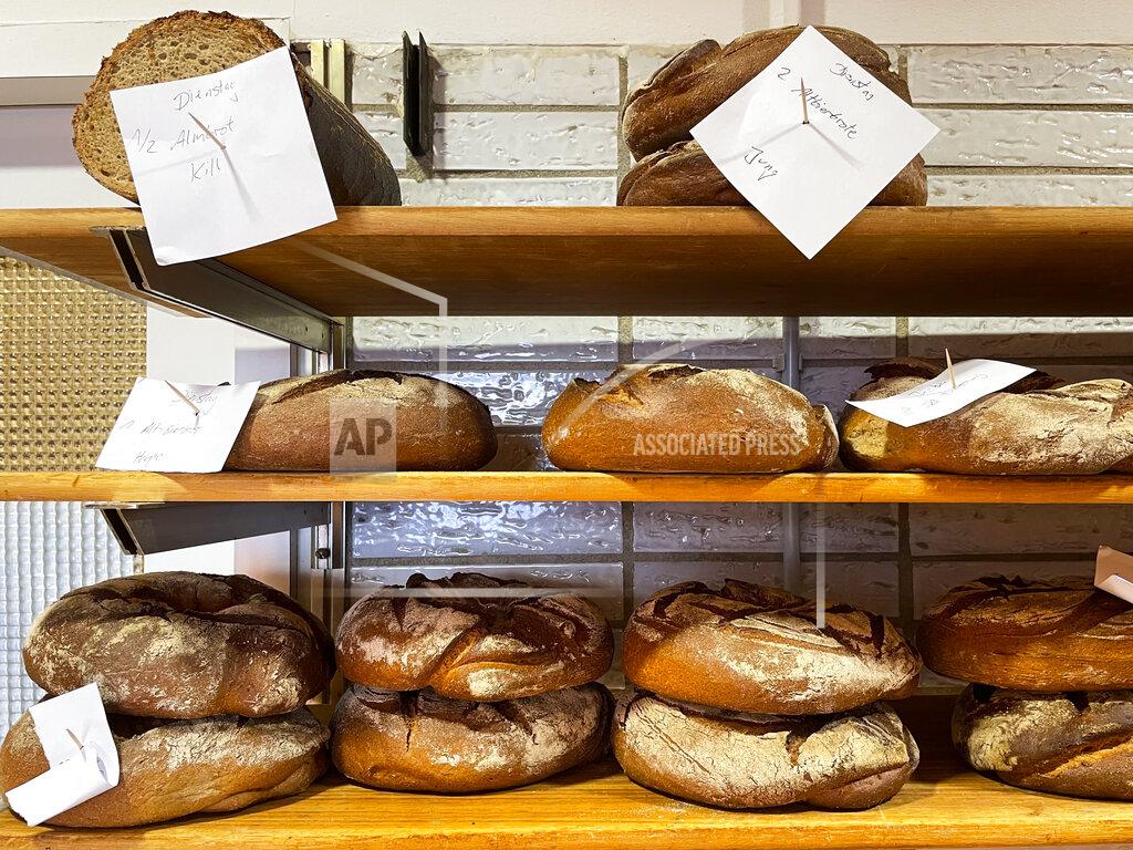 Daniel Niemann Bread that was baked with beer is displayed at the Coelven bakery in Duesseldorf, Germany, Tuesday, March 23, 2021. The historic Fuechschen brewery in Duesseldorf, has about 6,000 litres of its renowned copper-colored 'Altbier' unsold and nearing its expiry date. The brewery is now working with craft bakers who use the beer to make bread, with about twelve bakeries producing the grain bread and are giving the additional bonus of a bottle of Fuechschen's Altbier free of charge with every loaf.(AP Photo/Daniel Niemann)