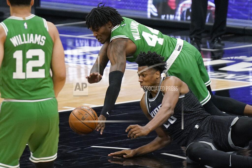Rich Pedroncelli Sacramento Kings center Hassan Whiteside, right, and Boston Celtics center Robert Williams III, background, dive for the ball during the second half of an NBA basketball game in Sacramento, Calif., Wednesday, Feb. 3, 2021. The Kings won 116-111. (AP Photo/Rich Pedroncelli)