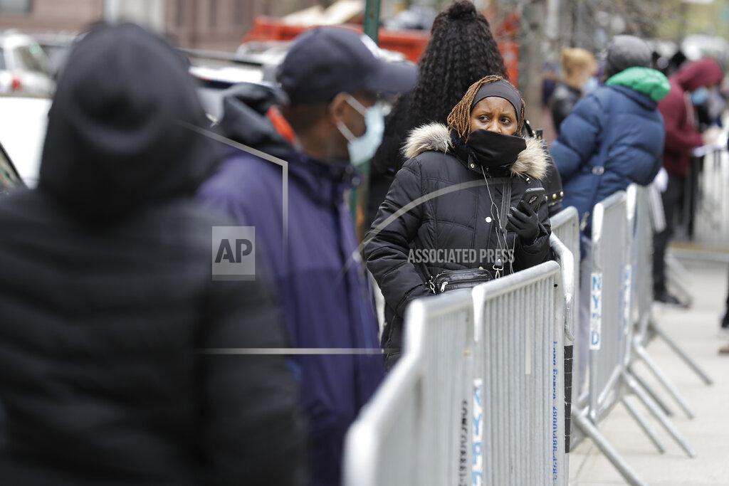 Seth Wenig People stand in line as they wait to get tested for COVID-19 at a just opened testing center in the Harlem section of New York, Monday, April 20, 2020. Hundreds of thousands of New Yorkers would need to be tested for the coronavirus daily before city officials could start to loosen restrictions that have shuttered most workplaces and forced residents to cover their faces in public, New York Mayor Bill de Blasio said Monday. (AP Photo/Seth Wenig)