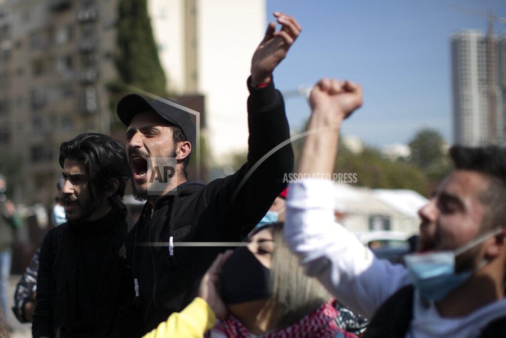 Hassan Ammar Anti-government protesters shout slogans outside a military court, in Beirut, Lebanon, Monday, Feb. 8, 2021. Riot police briefly clashed Monday in Beirut with hundreds of protesters demanding the release of anti-government activists detained following riots in northern Lebanon late last month. (AP Photo/Hassan Ammar)