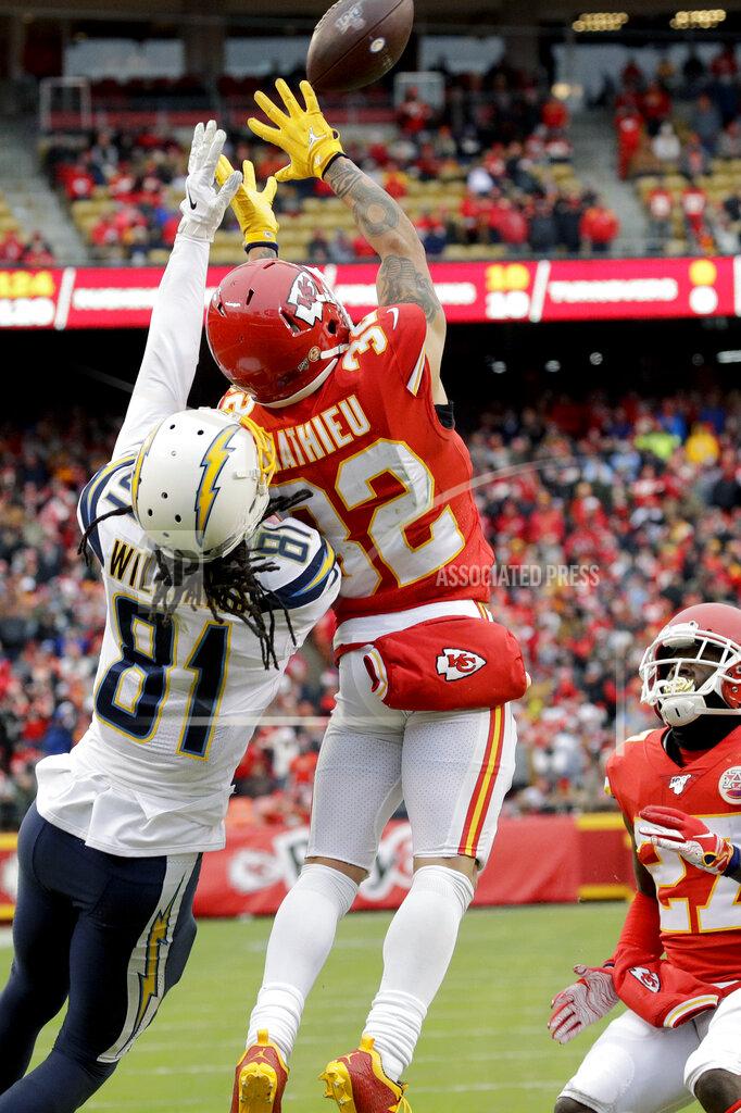 Charlie Riedel Kansas City Chiefs safety Tyrann Mathieu (32) intercepts a pass intended for Los Angeles Chargers wide receiver Mike Williams (81), as cornerback Rashad Fenton (27) watches, during the first half of an NFL football game in Kansas City, Mo., Sunday, Dec. 29, 2019. (AP Photo/Charlie Riedel)