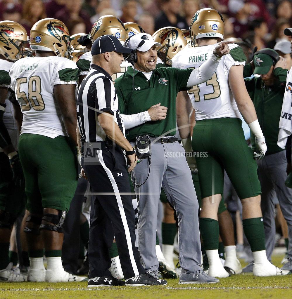 Michael Wyke UAB coach Bill Clark talks with official Chad Lorance during the first half of the team's NCAA college football game against Texas A&M on Saturday, Nov. 17, 2018, in College Station, Texas. (AP Photo/Michael Wyke)