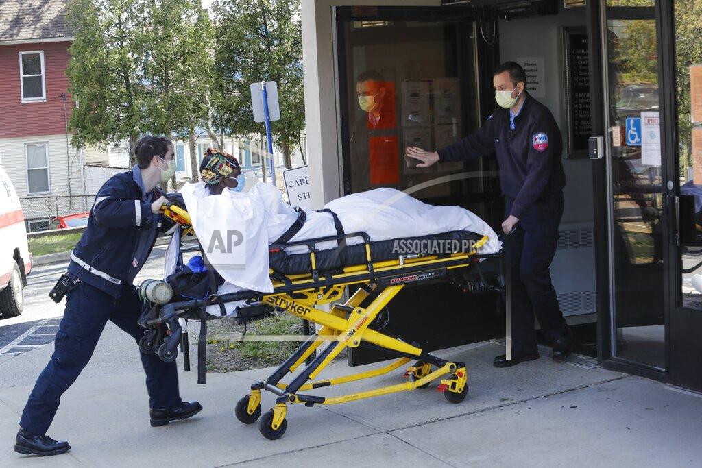 Frank Franklin Ii FILE - In this April 22, 2020, file photo medical workers bring a patient to the Northbridge Health Care Center in Bridgeport, Conn. A report from Senate Democrats finds that the Trump administration was slow to comprehend the scale of COVID-19's impact on nursing homes and a disjointed federal response only compounded the devastating toll. (AP Photo/Frank Franklin II)