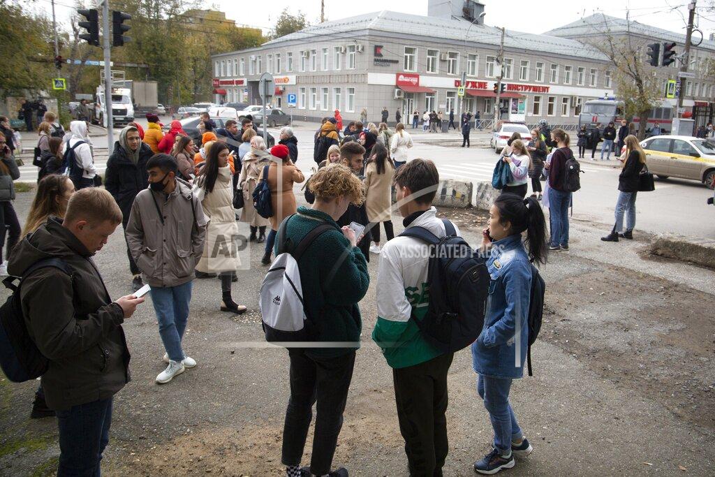 Anastasia Yakovleva A group of students gather at the Perm State University in Perm, about 1,100 kilometers (700 miles) east of Moscow, Russia, Monday, Sept. 20, 2021. A gunman opened fire in a university in the Russian city of Perm on Monday morning, leaving at least eight people dead and others wounded, according to Russia's Investigative Committee. (AP Photo/Anastasia Yakovleva)