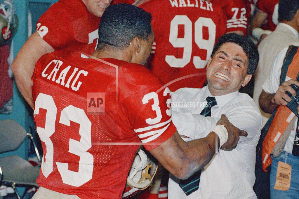 Anonymous FILE - In this Jan. 23, 1989, file photo, San Francisco 49ers owner Edward DiBartolo Jr. hugs 49ers running back Roger Craig (33) in the locker room after the 49ers 20-16 victory over the Cincinnati Bengals in Super Bowl XXIII in Miami. (AP Photo/File)