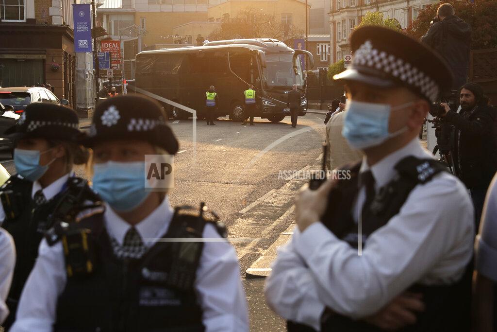 Matt Dunham The buses carrying the Chelsea and Brighton teams arrive at Stamford Bridge stadium in London, protected by a police line, as fans protest against Chelsea's decision to be included amongst the clubs attempting to form a new European Super League, Tuesday, April 20, 2021. Reaction to the proposals from 12 clubs to rip up European soccer by forming a breakaway Super League has ranged from anger and condemnation to humor and sarcasm. (AP Photo/Matt Dunham)